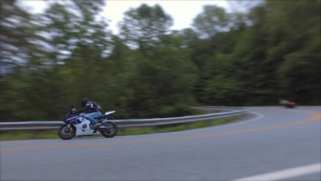 fast motorcycles taking tight corner in opposite direction vermont hairpin corner appalachain gap highway 17