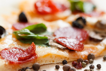 A hot pizza slice with dripping melted cheese. Isolated on white.