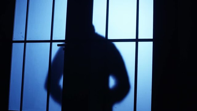 Silhouette of a killer or serial maniac with knife entering to the room but he listen or see anybody and escaping back . Shot on RED EPIC Cinema Camera.
