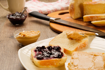 peanut butter sandwich with jam on cutting board