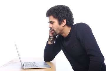 Afro man behind a desk