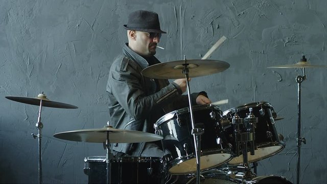 Professional and stylish rock drummer playing on drum set. Shot on RED HELIUM cinema camera in slow motion.