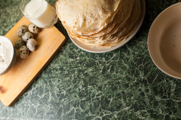 Ingredients for preparation of pancakes, on wooden background