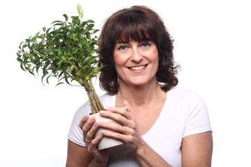 Mature woman with a plant