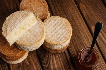 Top View of Crafted Cheese on Wooden Background with Free Space for Text at the Right Side of the Photo.