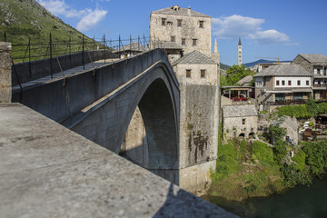 Fototapeta na wymiar View of the single-arch Old Bridge or Stari Most Neretva over River in Mostar, Bosnia and Herzegovina. The Old Bridge was destroyed in 1993 by Croat military forces during the Croat–Bosniak War. 