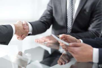 Two confident businessmen shaking hands during a meeting in the