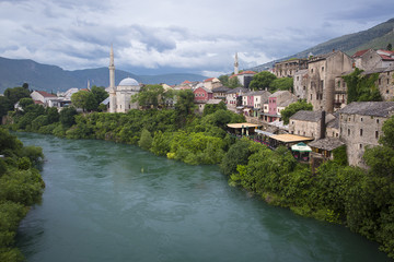 Fototapeta na wymiar Old town, Koski Mehmed Pasa mosque and Neretva River, Mostar, Bosnia and Herzegovina. The old town was destroyed during the Croat-Bosniak war in 1993