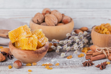 Ingredients for cooking bread or cookies: honeycomb, flour, raisines, mix of nuts, spices