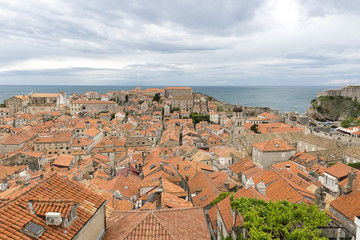 Fototapeta na wymiar View over the orange rooftops of old town Dubrovnik from the ancient city wall with cloudy weather, Croatia