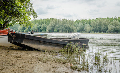 Wooden boat moored on the lake shore 