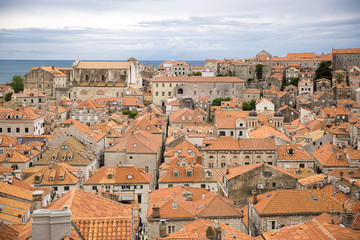 View over the orange rooftops of old town Dubrovnik from the ancient city wall with cloudy weather, Croatia