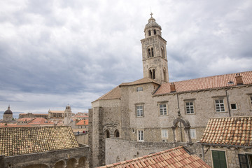 Fototapeta na wymiar Saint Dominic Church bell tower and red roofs of old buildings in old town Dubrovnik, Croatia