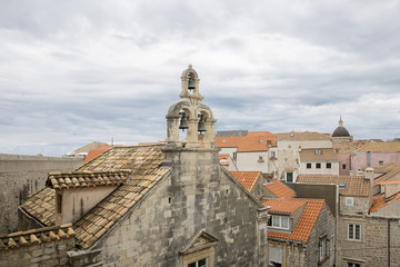 View over the orange rooftops of old town Dubrovnik from the ancient city wall with cloudy weather, Croatia