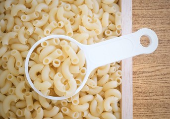 Top View of Elbow Macaroni in Measuring Cup