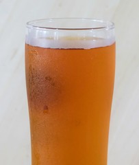 Cold Glass of Beer on Wooden Blackground