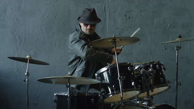 Professional and stylish rock drummer playing on drum set. Shot on RED HELIUM cinema camera in slow motion.
