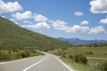road going through the sunny spring or summer countryside in south Croatia