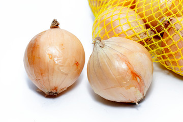 Fresh onions in a yellow plastic net