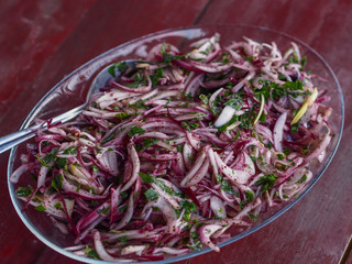 red onion salad on wood table