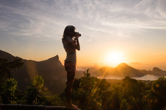 Girl Taking pictures sunrise in Vista Chinesa, Rio de Janeiro, Brazil
