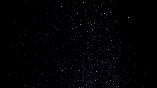 Real golden dust falling down in front of black background. This footage can be used on first plan of different videos by blend modes Overlay or Screen. Shot on RED cinema camera .