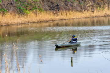 Fototapeta na wymiar Novi Sad, Serbia March 18, 2018: Boatman oars on the Danube-Tisa-Danube canal 