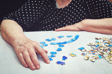 Old lady doing a puzzle