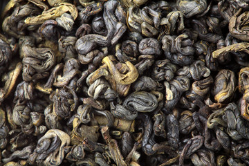 Green tea texture.Closeup.Macro shot.Pile of dry green tea.