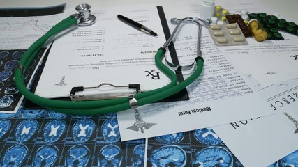 A doctor's table with pills and syrups in a modern hospital. Stethoscope with a dropper and syringes in the medical office. A nurse writes a prescription to a sick patient. The doctor checks new drugs - Powered by Adobe