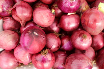 Pile of red onions at the market.
