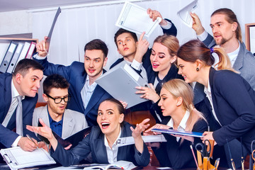 Business people office life of team people are happy with hand up sitting table and working papers. Cabinets with folders and jalousie background. Firm increased its revenues for year.