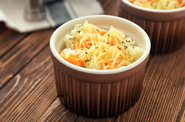 Ramekin with delicious pumpkin risotto on wooden table