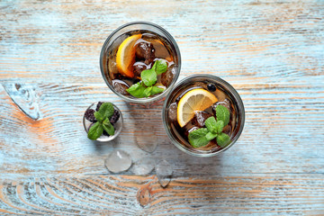 Glasses of fresh lemonade on wooden table