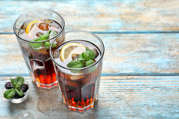 Glasses of fresh lemonade on wooden table