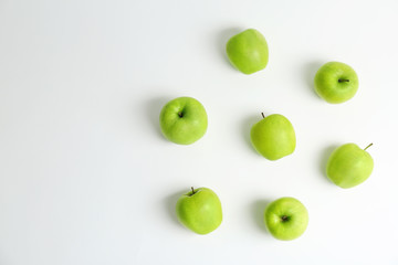 Fototapeta na wymiar Fresh green apples on white background, top view