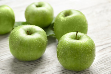Fresh green apples on wooden background
