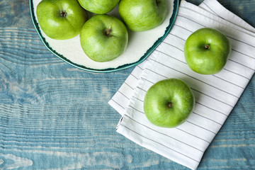 Fresh green apples on wooden table, top view