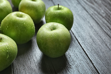 Fresh green apples on wooden background