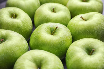 Fresh green apples with water drops, closeup