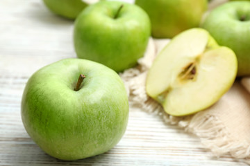 Fresh green apples on wooden table