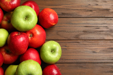 Fresh ripe red apples on wooden background