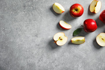 Fresh ripe red apples on light grey background
