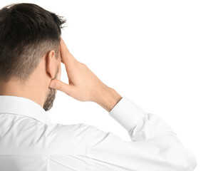 Young man suffering from headache on white background