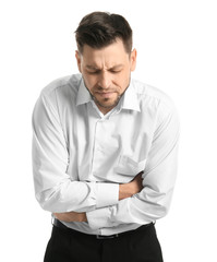 Young man suffering from abdominal pain on white background