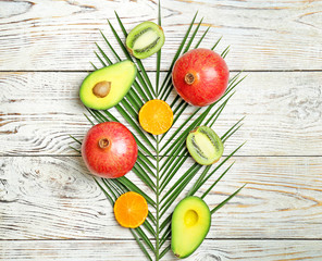Beautiful composition with fresh tropical fruits on wooden background