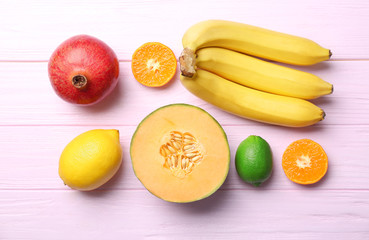 Set of fresh tropical fruits on color background