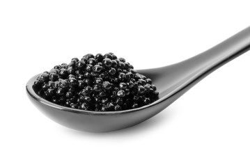 Ceramic spoon with black caviar on white background