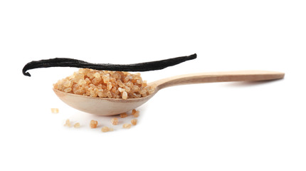 Spoon with brown vanilla sugar and sticks on white background