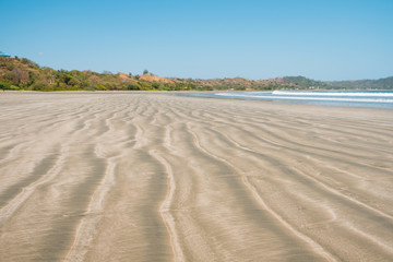 beach sand closeup with blurred landscape background